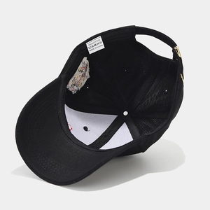 Interior of black cotton baseball cap with lion embroidery and adjustable strap