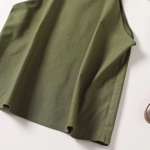 Detailed close-up of grass green cotton linen sleeveless top showing natural fabric texture