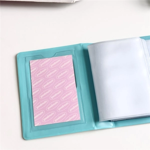 Detail of blue PVC photocard album showing clear inner pockets and pink goodmate card