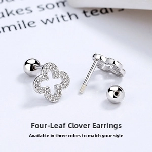 Macro shot of silver four-leaf clover stud earrings with white zircon pavé and screw back