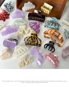 Detailed top view of assorted acetate hair claws in marble and tortoiseshell patterns