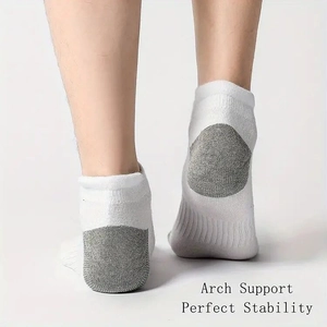 Detail of white athletic socks showing arch support and perfect stability on heel