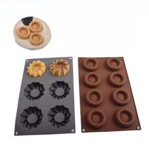 Macro detail of food grade silicone baking molds showing 6-hole flower and 8-hole ring shapes