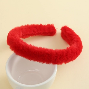 Close-up of soft red plush headband showing fluffy texture on a white ceramic cup