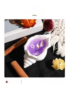 Detail of a conch shell aromatherapy candle with purple jelly wax, pearls and sea stars