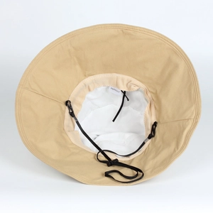 Detail of khaki sun hat featuring a wide flat brim and adjustable black windproof strap