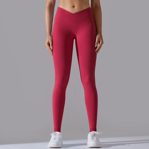Detail of high-waist seamless yoga leggings showing cross V-waist design and ribbed texture