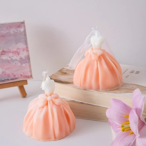 Creative wedding dress scented candle in pink and white on vintage books with tulips