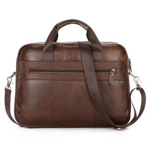 Close-up of dark brown genuine leather business briefcase with bronze metal hardware