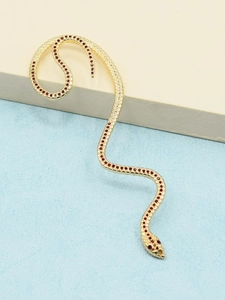 Detailed view of a gold snake-shaped ear cuff with sparkling red rhinestones design