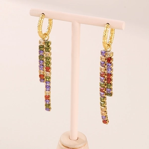 Gold-plated tassel earrings with colorful square-cut zircons on a jewelry display stand