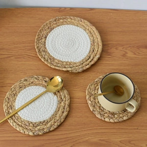 Nordic woven round cotton rope placemats and coasters on a wooden table setup