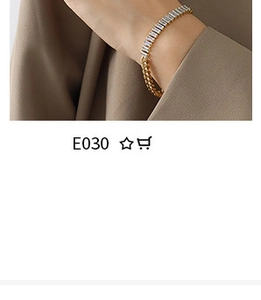 Close-up of gold chain bracelet with rectangular clear gemstones on a model's wrist