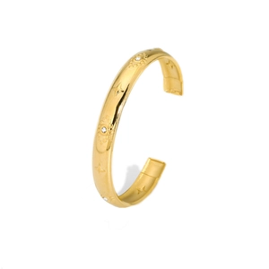 Gold stainless steel open bangle with engraved star and evil eye motifs and zircon inlay