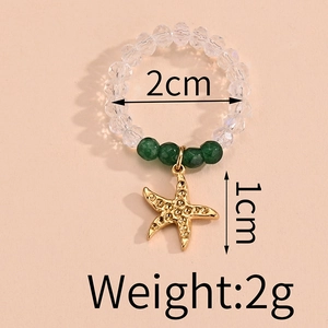 Detail of beaded ring with sea star charm including size labels 2cm and 1cm