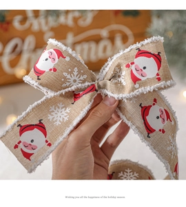 Detail of Christmas ribbon with plush edges and Santa Claus pattern for gift wrapping