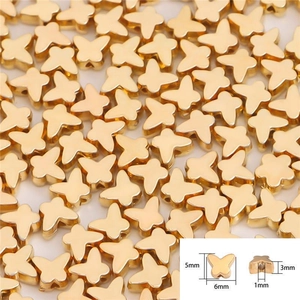 Macro shot of 6mm gold butterfly CCB spacer beads with detailed size measurements