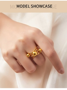 Detail of French retro gold layered ring with metallic beads on a silk background