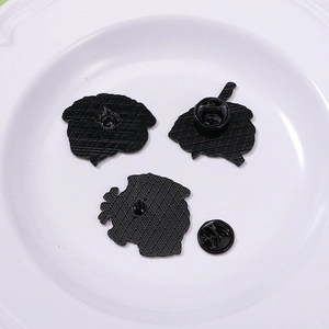 Three-piece black anatomical enamel pins showing back texture and butterfly clasp details