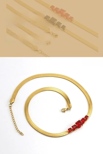 Detail of 18k gold plated snake chain necklace with five square red zircon pendants
