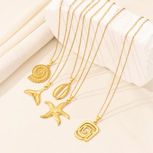 Detailed display of gold ocean pendants featuring starfish, shell and whale tail designs