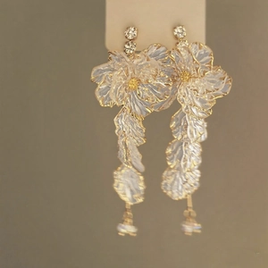 Elegant white acrylic flower petal drop earrings with gold edges and crystal accents