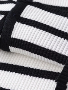 Detailed close-up showing the knit ribbed texture and black and white striped fabric pattern