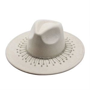 Detail of bridal suede fedora featuring sparkling crystal fringe trim and wide brim design