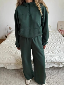 Women's dark green lounge set with half-zip sweatshirt and matching straight-leg trousers