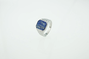 Close-up of square lapis lazuli stone on a men's steel signet ring with geometric etching