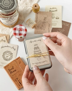 Macro shot of 30pcs vintage life imprint scrapbooking stickers in a stylish tin box