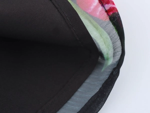 Detail of double-layer hem with pink floral chiffon and black lining showing fine stitching