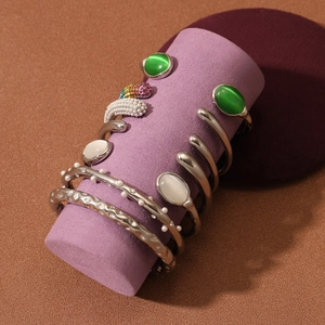 Collection of polished stainless steel open bangles with cat eye stones and pearls