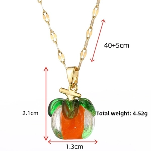 Detail view of pumpkin glass necklace with dimensions 2.1x1.3cm and 40+5cm gold chain