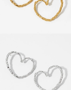 Detail of lava texture hollow heart earrings in gold and silver stainless steel