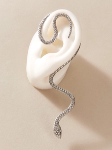 Detail view of silver snake ear cuff with sparkling zircons on a white model ear