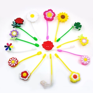 Close-up of colorful flower silicone charms including roses and daisies for straw covers