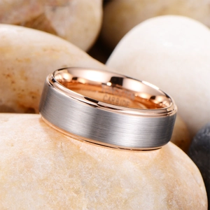 Brushed silver tungsten carbide ring with rose gold interior on stones