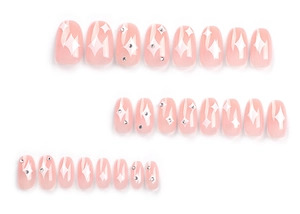 Detail of 24 light pink round press-on nails with white stars and rhinestones