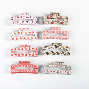Set of eight Christmas hair claws featuring reindeer, tree, and snowflake patterns on white