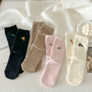 Four pairs of warm fleece socks with cute animal embroidery in camel, pink, and white