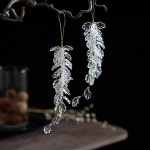 Makro-Detail von transparenten Acryl-Anhängern an Goldfäden für die Weihnachtsdeko
