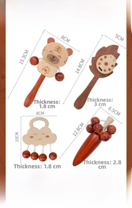 Detailed view of wooden baby rattles in tiger and cloud shapes with material specifications