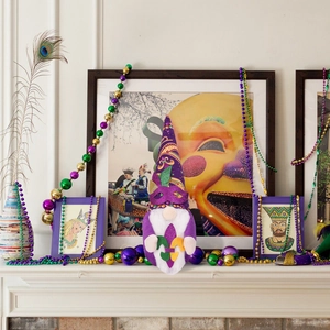 Mardi Gras gnome plush ornament in purple green and gold displayed on festive mantel