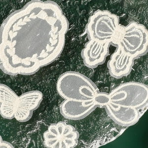 Off-white lace embroidery patches featuring bowknot, butterfly, and flower patterns on mesh fabric