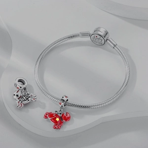 Detail of silver snake chain bracelet with red crab charms and Family IS FOREVER clasp