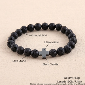 Detail view of 8mm black lava stone beads and black cholite cross pendant on stretch bracelet