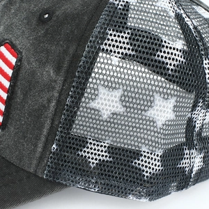 Detail of washed cotton baseball cap with US flag embroidery and star pattern mesh back