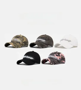 Detailed view of 3D embroidery and vintage distressed brim on camouflage baseball caps