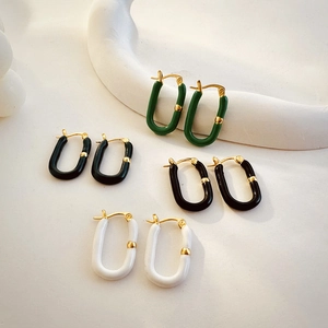 Detail of colorful U-shaped 18K gold plated stainless steel earrings with drip oil finish